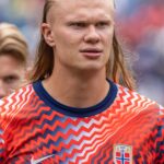 Erling Haaland in Norway national team kit running on the pitch during a match