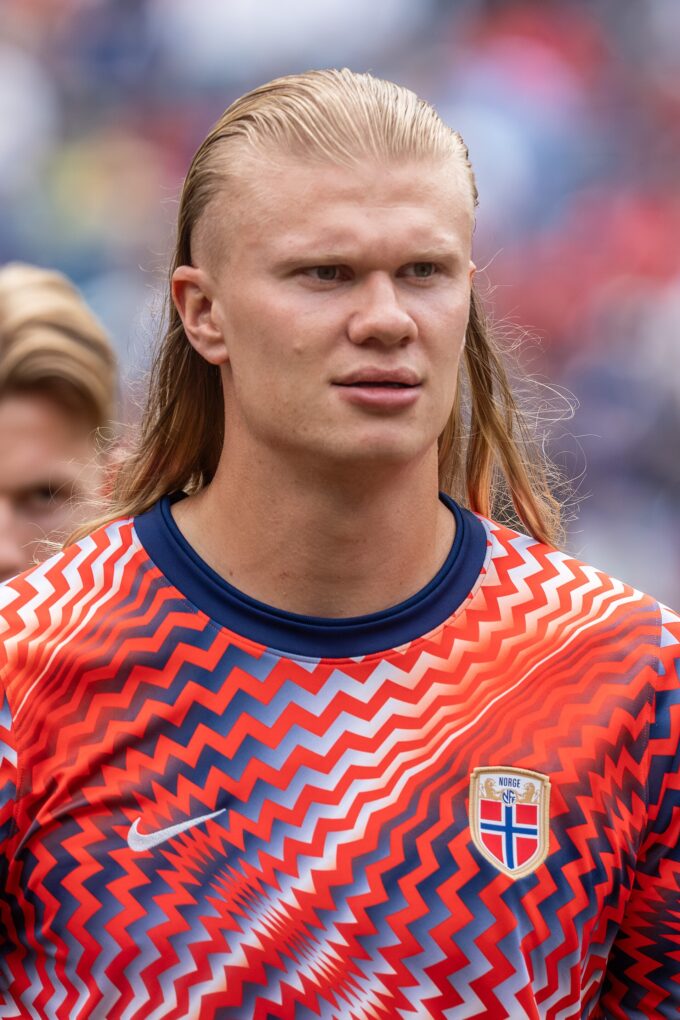 Erling Haaland in Norway national team kit running on the pitch during a match