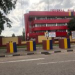 Exterior of the Federal Fire Service building in Abuja showing the service signage and parked vehicles