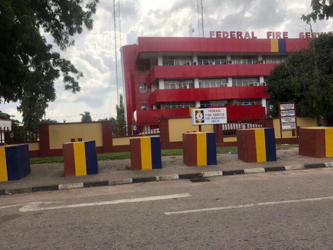Exterior of the Federal Fire Service building in Abuja showing the service signage and parked vehicles