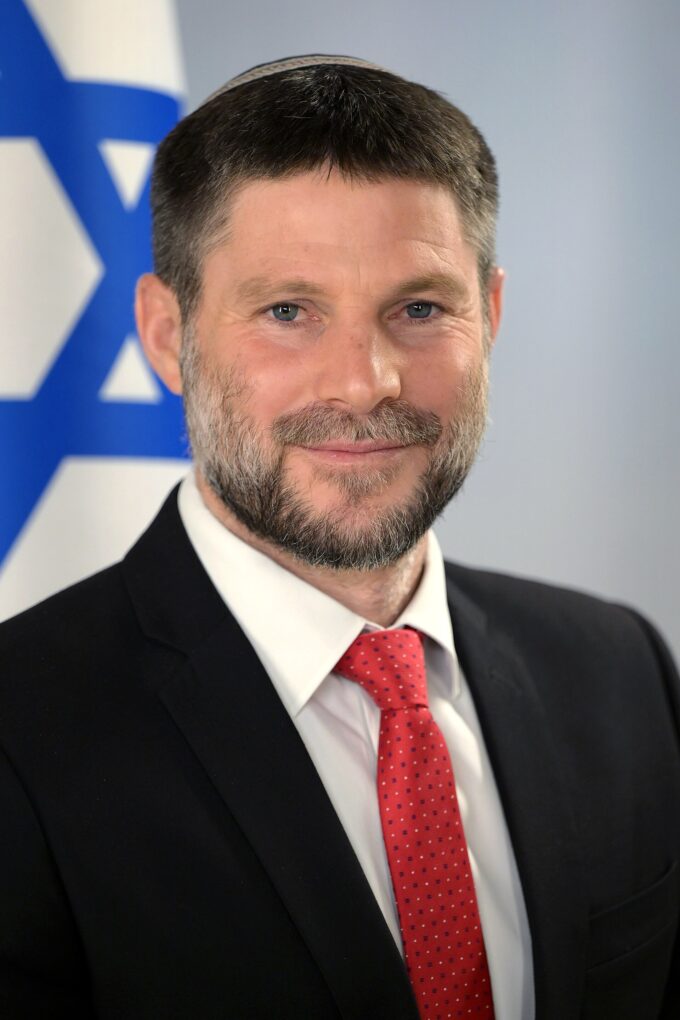 Portrait of Bezalel Smotrich wearing a dark suit and tie, facing forward