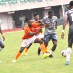 Shooting Stars players contest the ball with Akwa United during a NPFL match at Goodwill Akpabio Stadium