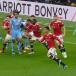 Manchester United and Manchester City players on the pitch at Old Trafford during a November 2021 match