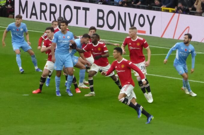 Manchester United and Manchester City players on the pitch at Old Trafford during a November 2021 match