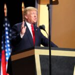 Donald Trump speaking at a podium to delegates at the Republican National Convention, July 2016