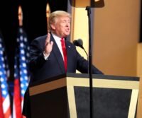 Donald Trump speaking at a podium to delegates at the Republican National Convention, July 2016
