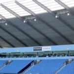 Exterior view of the Etihad Stadium, Manchester City's home ground, showing stands and floodlights