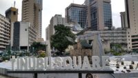 Tinubu Square in Lagos with traffic, buses and surrounding buildings