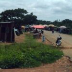 Sabon Gari Chori market junction in Kaduna State with street stalls and buildings