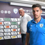 Manor Solomon at a press conference with microphones and Israel Football Association signage behind him