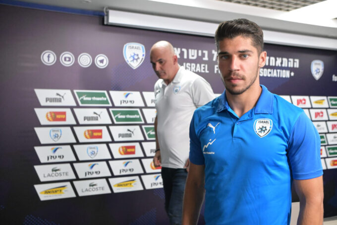 Manor Solomon at a press conference with microphones and Israel Football Association signage behind him