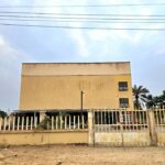 Exterior view of a modern theatre building in Badagry with an entrance and windows