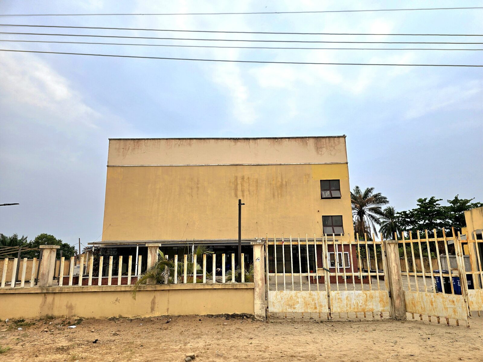 Exterior view of a modern theatre building in Badagry with an entrance and windows