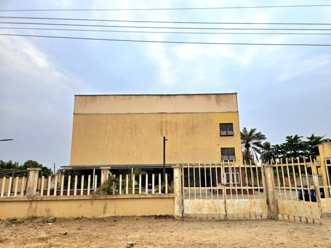 Exterior view of a modern theatre building in Badagry with an entrance and windows