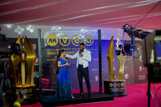 Ebuka Obi-Uchendu and Toke Makinwa onstage presenting at the 2020 AMVCA