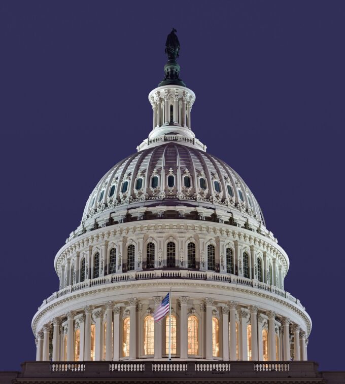 The dome of the United States Capitol building in Washington, D.C., against a blue sky.