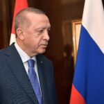 Turkish President Recep Tayyip Erdogan speaking at a podium during a 2020 visit to Germany